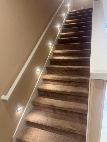 a hallway with sliding door and wooden floor