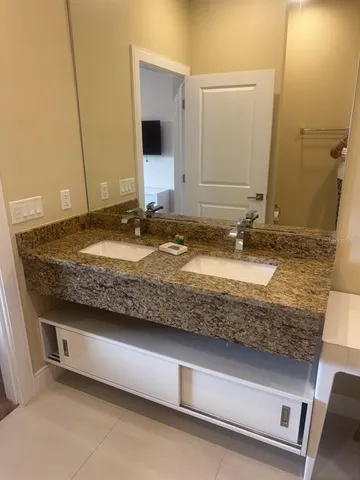 a bathroom with a shower and a sink