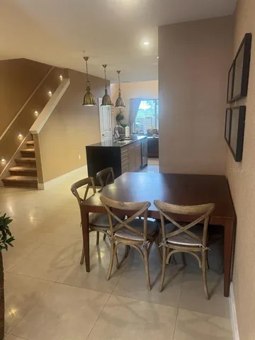 a kitchen with kitchen island granite countertop a sink stainless steel appliances and cabinets