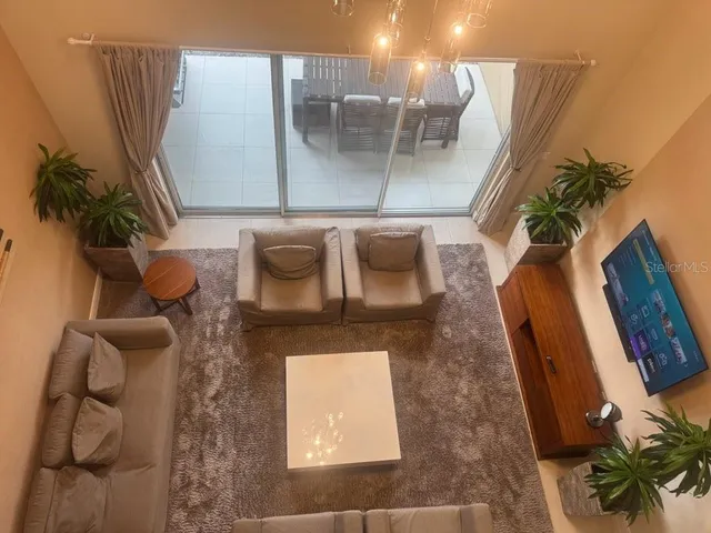 a living room with furniture and a large window