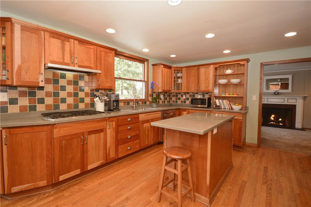 515 Guyasuta Road Aspinwall, PA 15215 - Photo 5 of 25 Enjoy this newer kitchen with loads of cabinetry and counter space, plenty of recessed lighting, tile backsplash, pristine hardwood floors, convenient island for prep work.