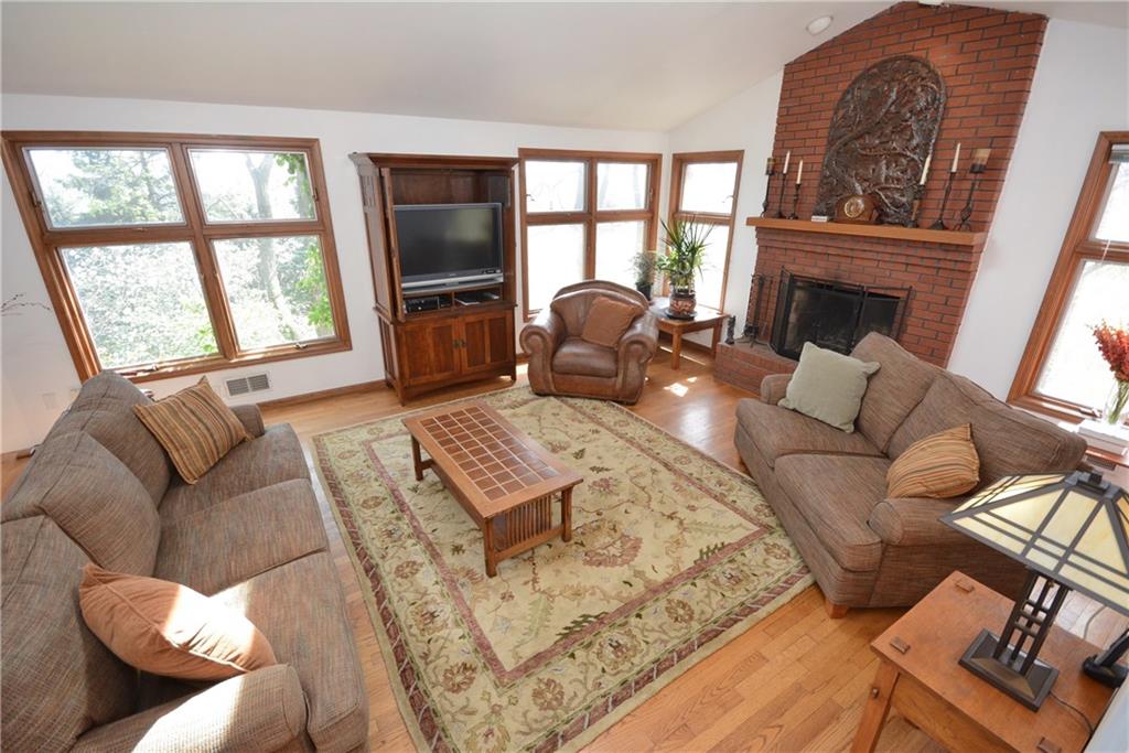 515 Guyasuta Road Aspinwall, PA 15215 - Photo 8 of 25 Spacious, bright living room with vaulted ceiling and beautiful fireplace, and hardwood floors.