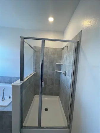 a bathroom with a glass door shower