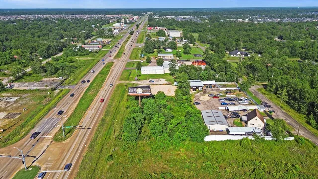 an aerial view of a residential houses with outdoor space and street view