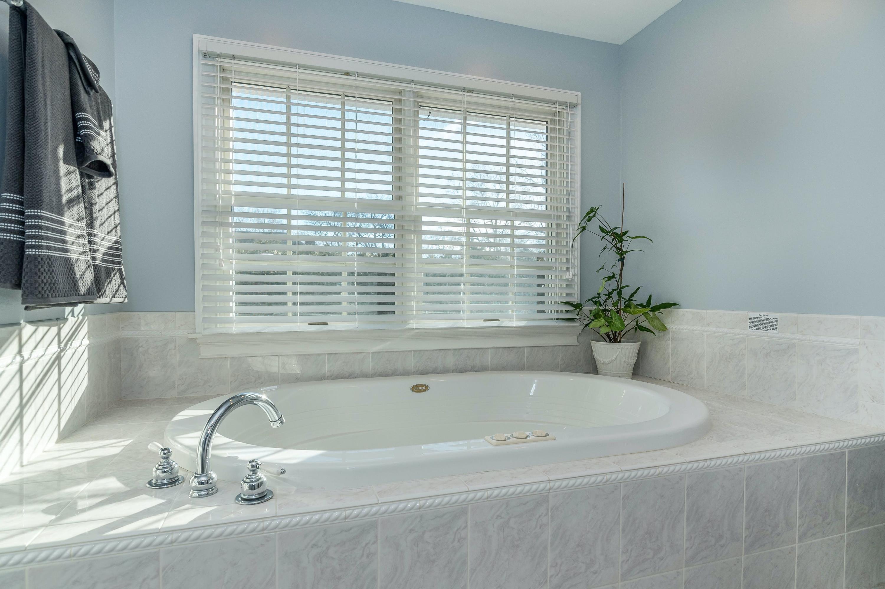 3 Fresh Meadows Lane Darien, CT 06820 - Photo 25 of 39 a bath tub sitting in a bathroom next to a window