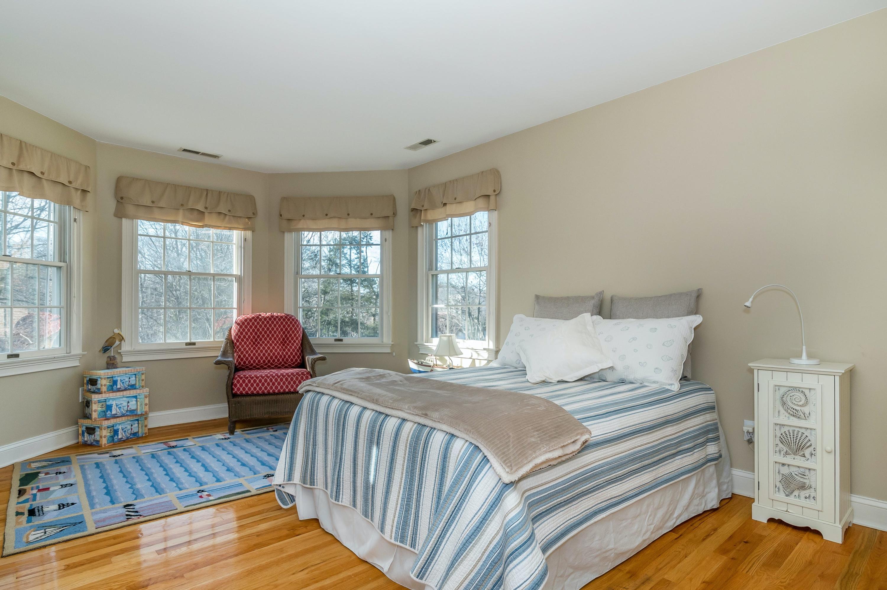 3 Fresh Meadows Lane Darien, CT 06820 - Photo 27 of 39 a bedroom with a bed and wooden floor