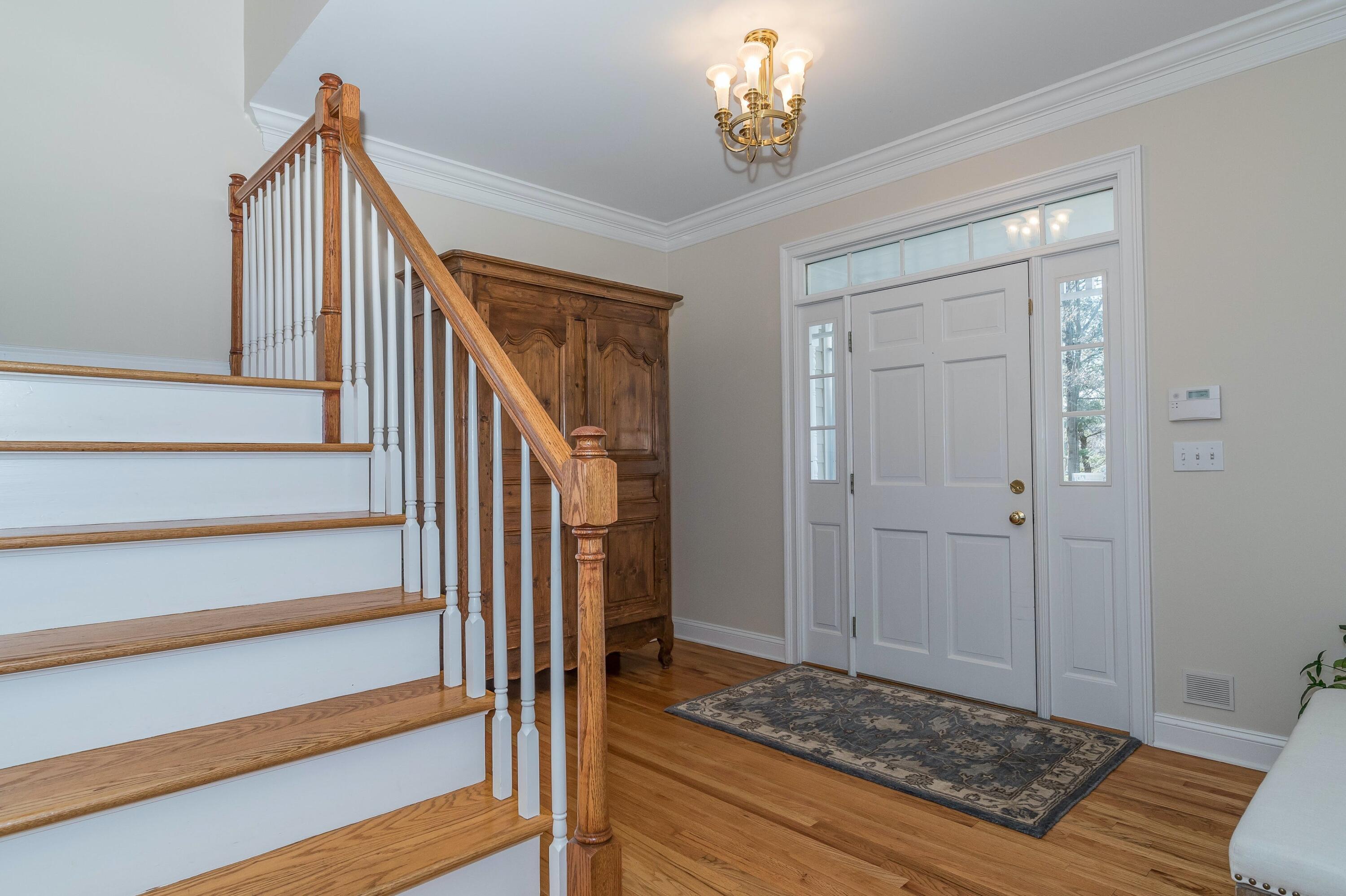 3 Fresh Meadows Lane Darien, CT 06820 - Photo 5 of 39 a view of a hallway to a bedroom and wooden floor