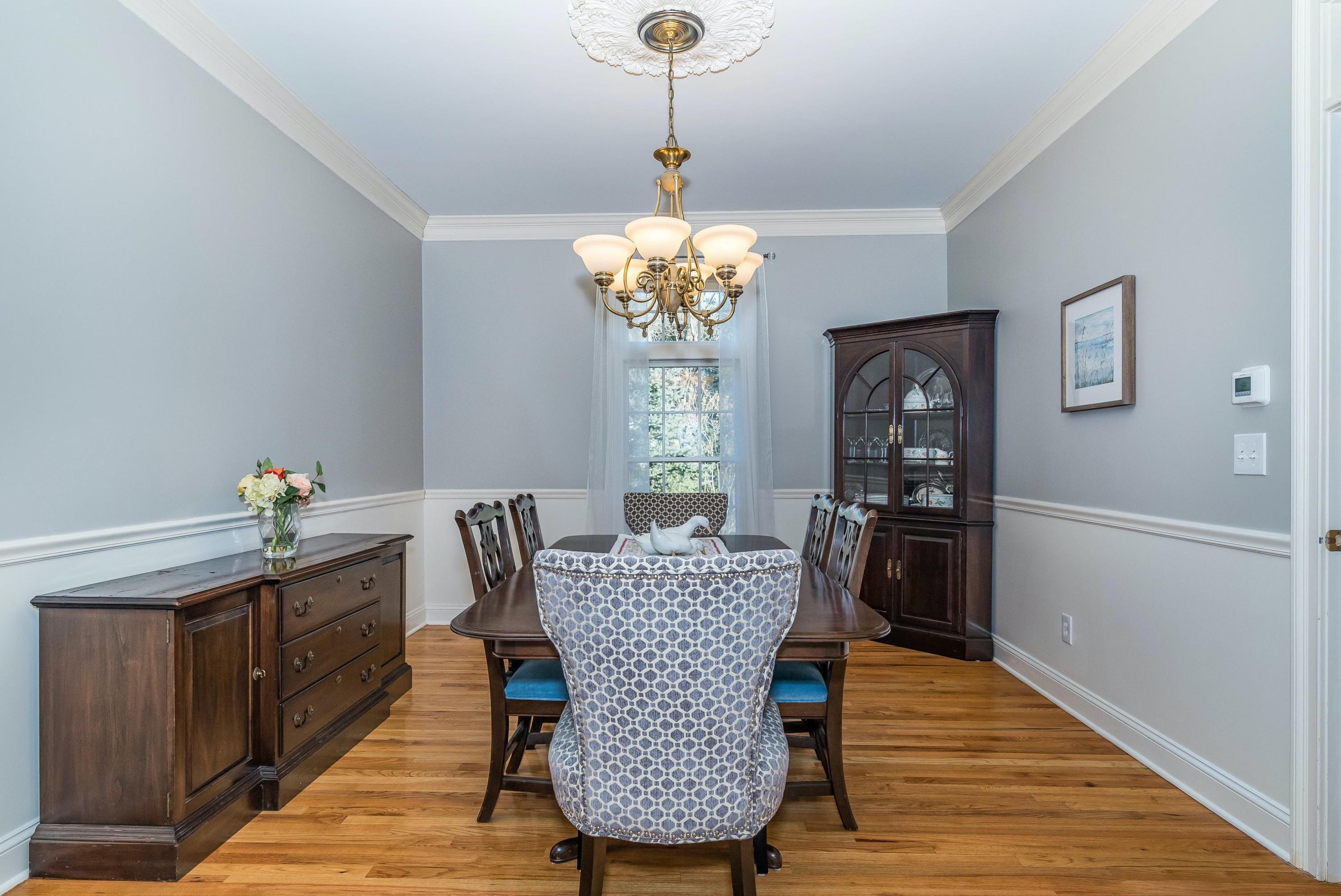 3 Fresh Meadows Lane Darien, CT 06820 - Photo 10 of 39 a dining room with furniture a chandelier and wooden floor