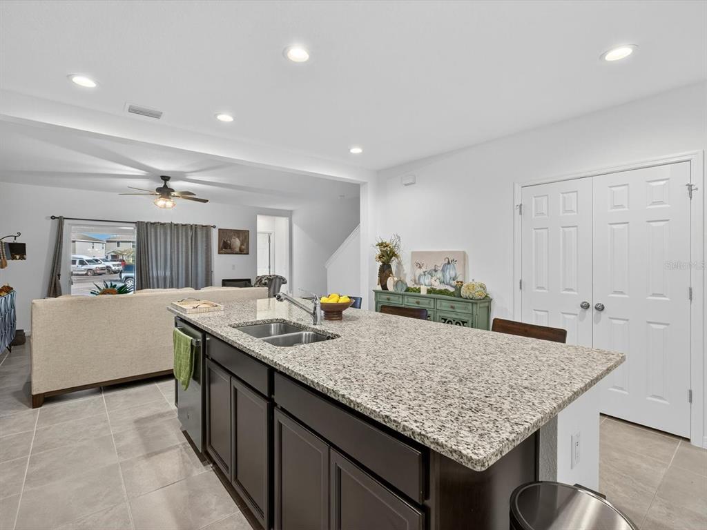 439 Annabelle Way Davenport, FL 33837 - Photo 11 of 31 a bathroom with a granite countertop sink and a mirror