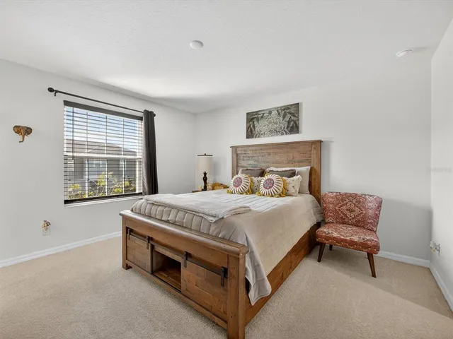 a bed sitting in a bedroom next to a window