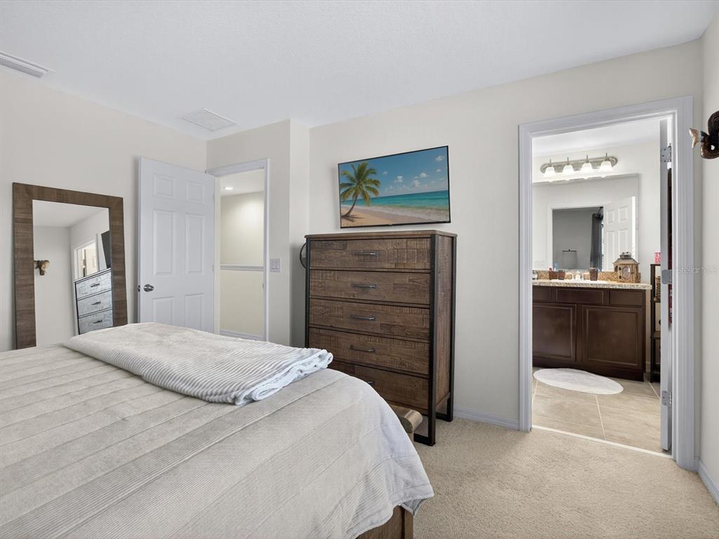 439 Annabelle Way Davenport, FL 33837 - Photo 16 of 31 a bedroom with a bed and a dresser