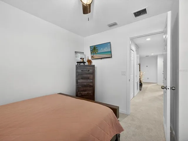 a bathroom with a granite countertop sink a toilet and shower curtain