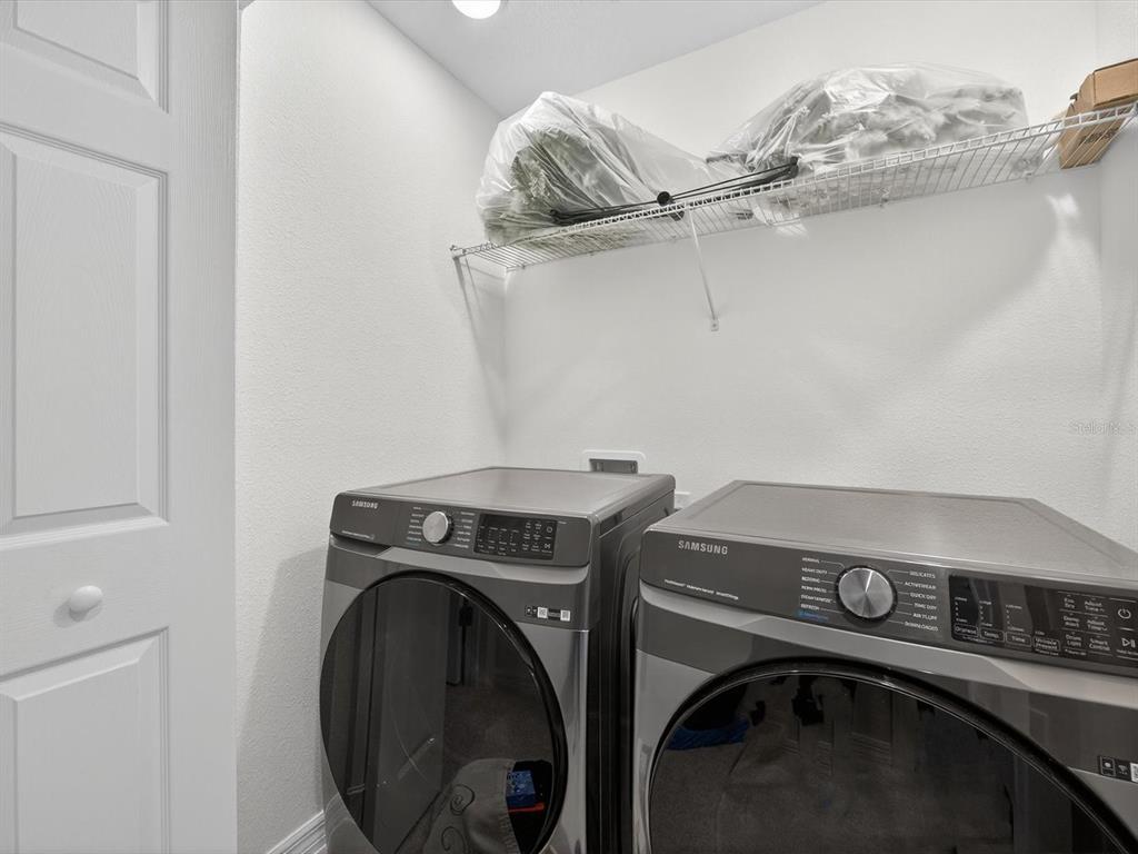439 Annabelle Way Davenport, FL 33837 - Photo 23 of 31 a utility room with dryer and washer