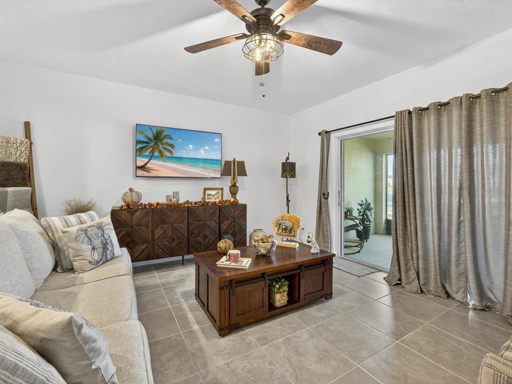 439 Annabelle Way Davenport, FL 33837 - Photo 5 of 31 a living room with furniture and a chandelier