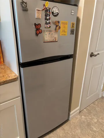 a white refrigerator freezer sitting inside of a kitchen