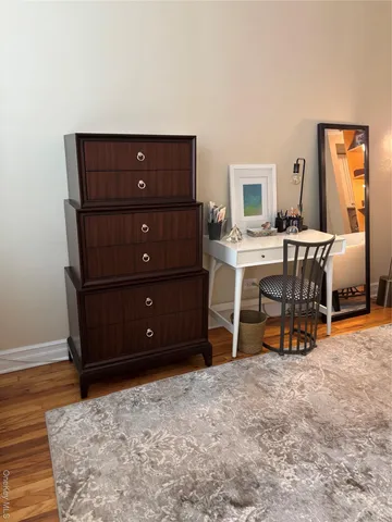 a room with a desk and a rug