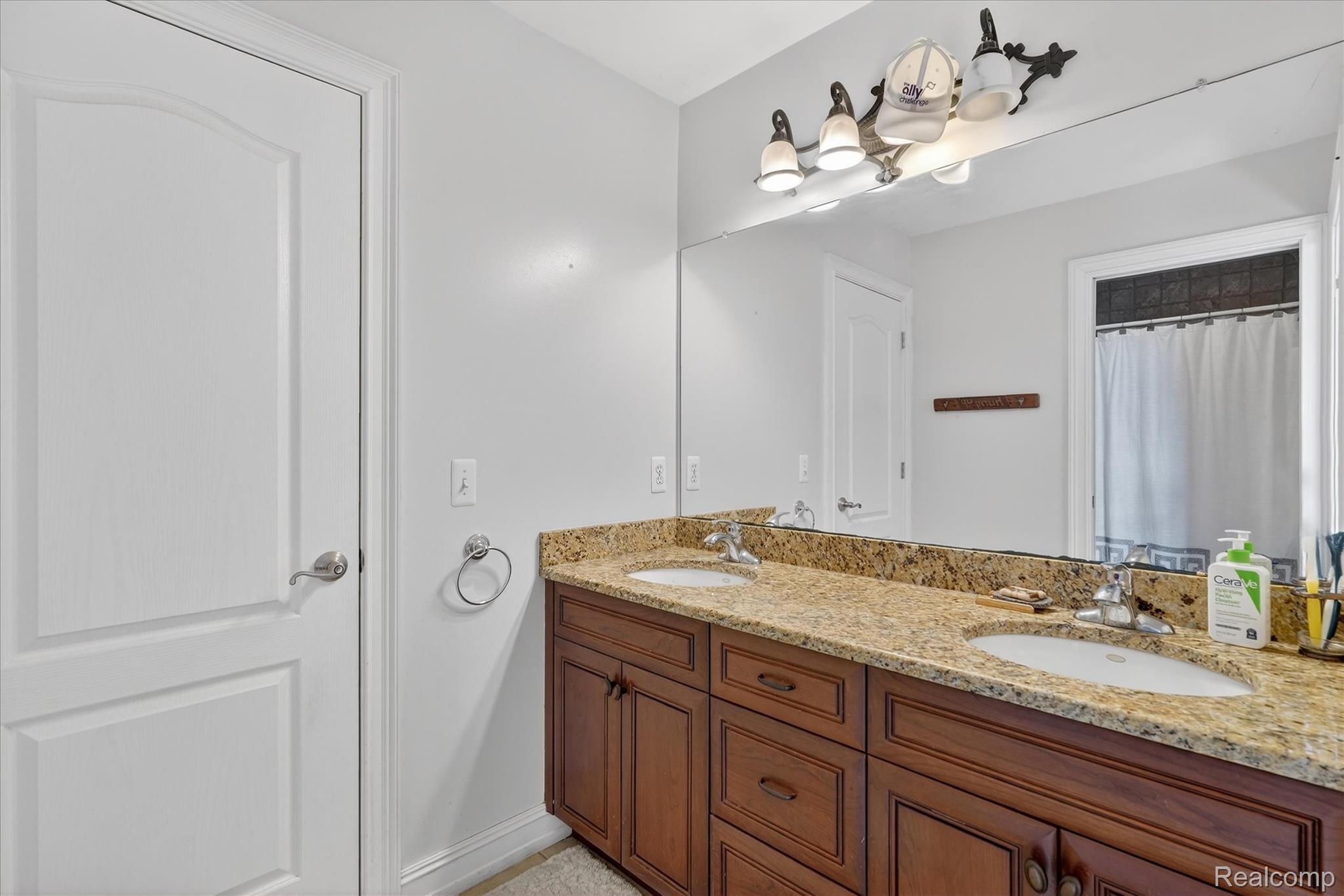 6932 Oakhurst Ridge Road Clarkston, MI 48348 - Photo 32 of 78 Full bath with double vanity and a shower with shower curtain