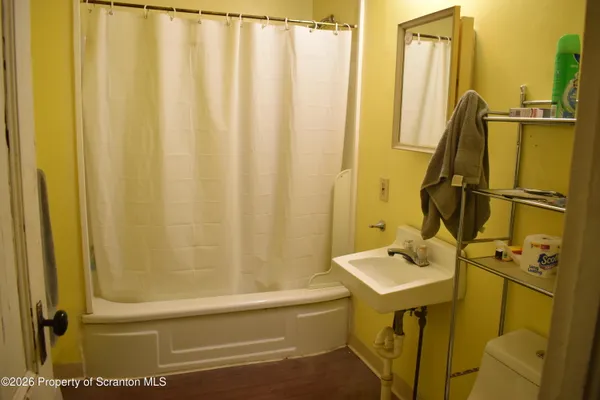 a bathroom with sink a mirror and a shower