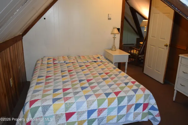 a bedroom with a bed and a mirror