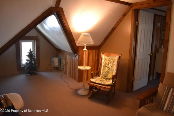 a hallway with chairs and a gate