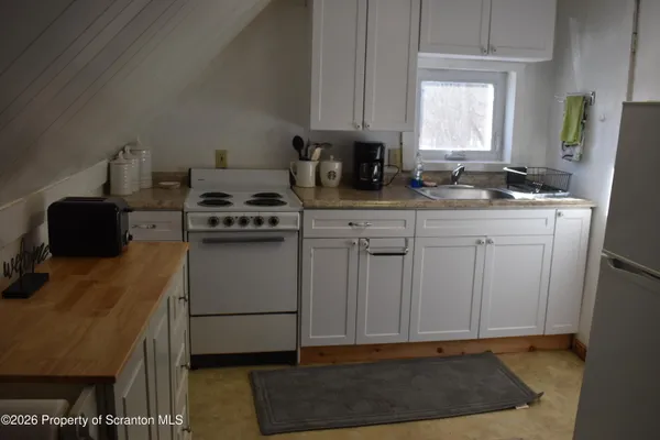 a kitchen with a sink cabinets and a window