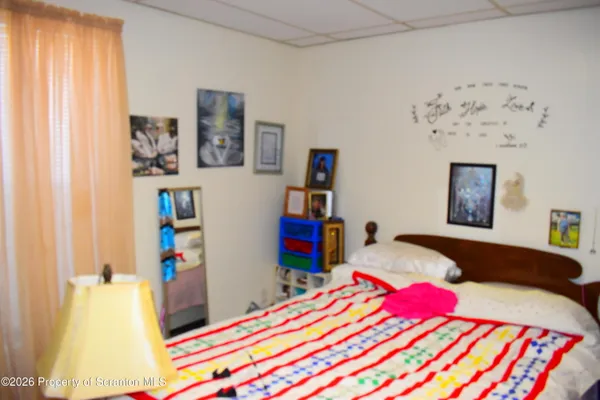 a bedroom with a bed and a dresser in it