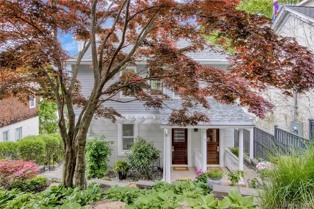 a front view of a house with garden