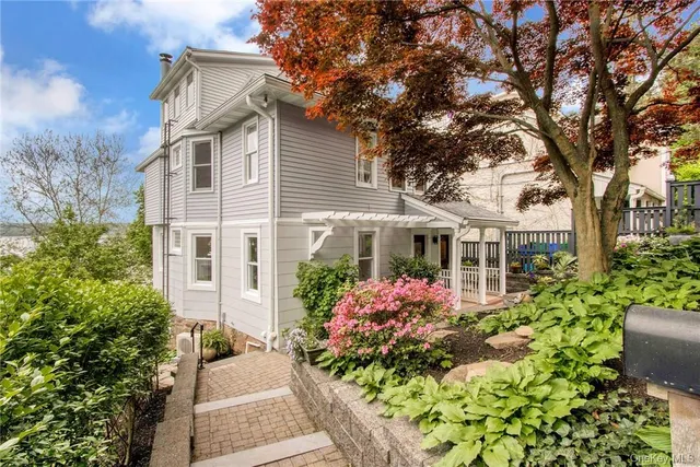 a front view of a house with a garden