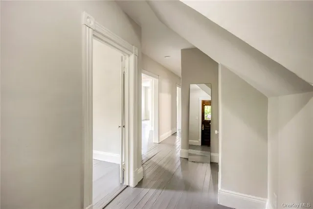 a view of hallway with wooden floor