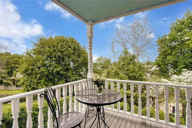 a view of a balcony with a table and chairs