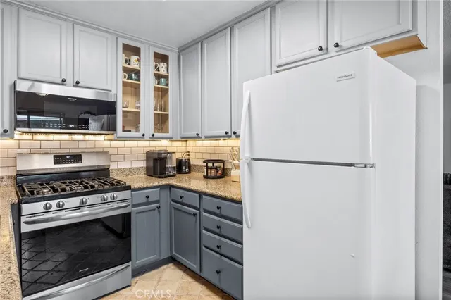 a white refrigerator freezer and a stove in a kitchen
