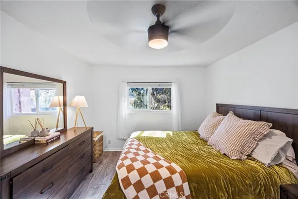 a bedroom with a bed and wooden floor