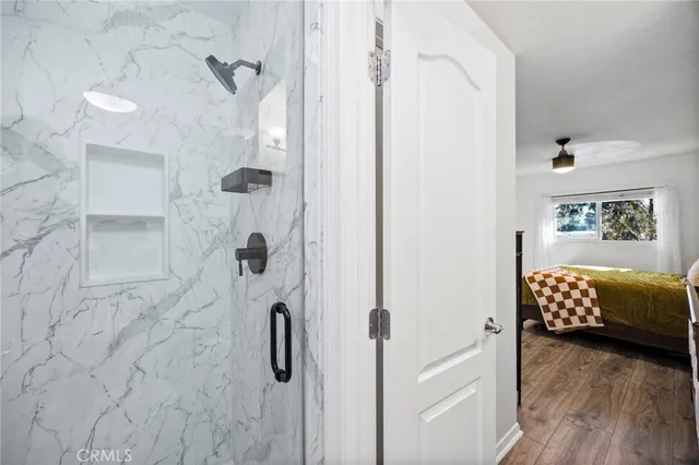 a bathroom with a tub shower and a mirror