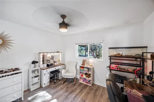 a view of a workspace with furniture and a window