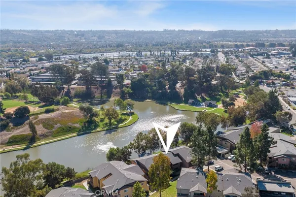 an aerial view of residential houses with outdoor space and river