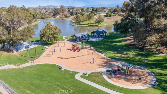 an aerial view of a city with lots of residential buildings ocean and mountain view in back