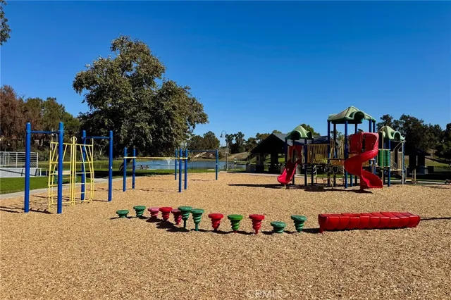an aerial view of a house with a yard and lake view
