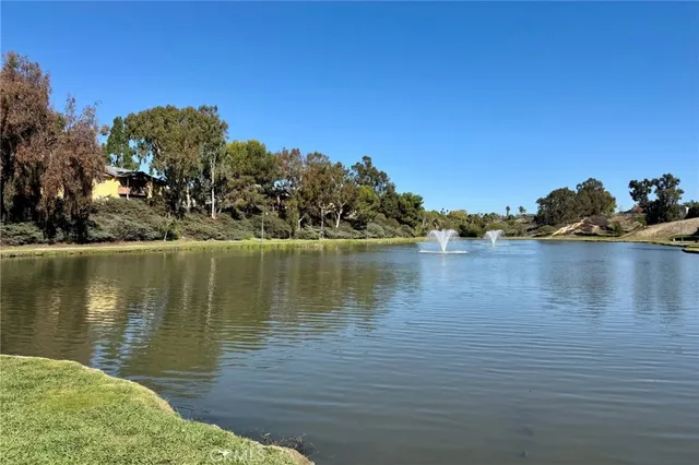 a view of a lake with houses in the back