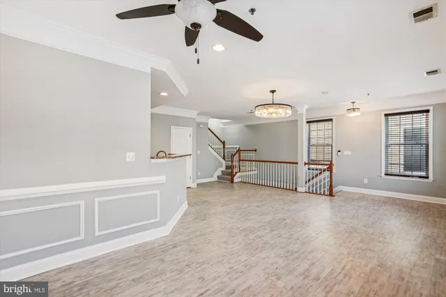 an entryway with a ceiling fan and windows