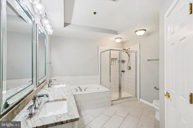 a bathroom with a tub sink and mirror