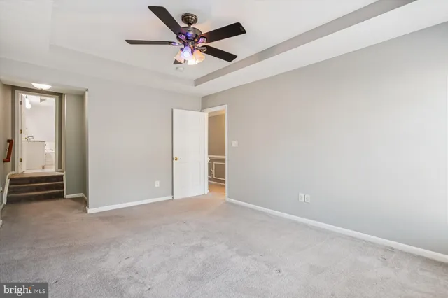 an empty room with a ceiling fan
