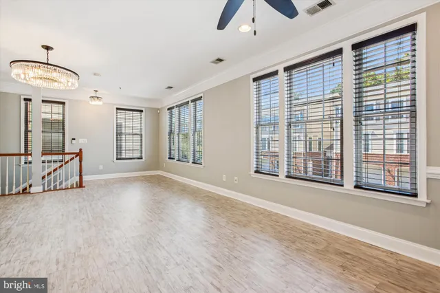 a view of an empty room with glass door and a window
