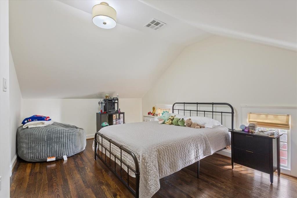 410 Rice Avenue Waco, TX 76708 - Photo 26 of 40 a bedroom with a bed and wooden floor