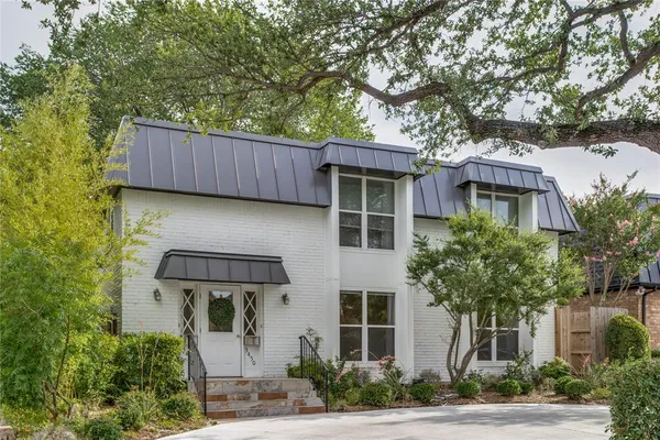 front view of a house with a tree