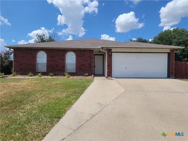 a front view of a house with yard and garage
