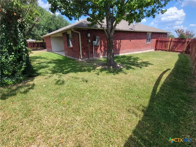 a large tree in front of a house