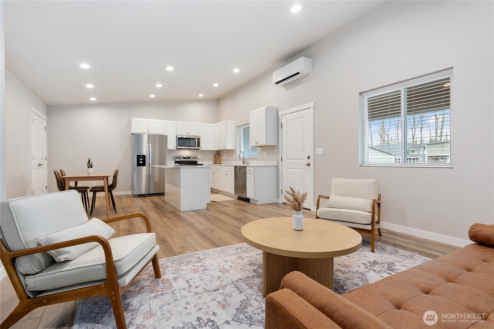 310 Everson Road, Unit C Everson, WA 98247 - Photo 15 of 37 a living room with furniture and a dining table with kitchen view