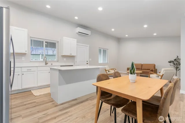a kitchen with a table chairs sink and cabinets