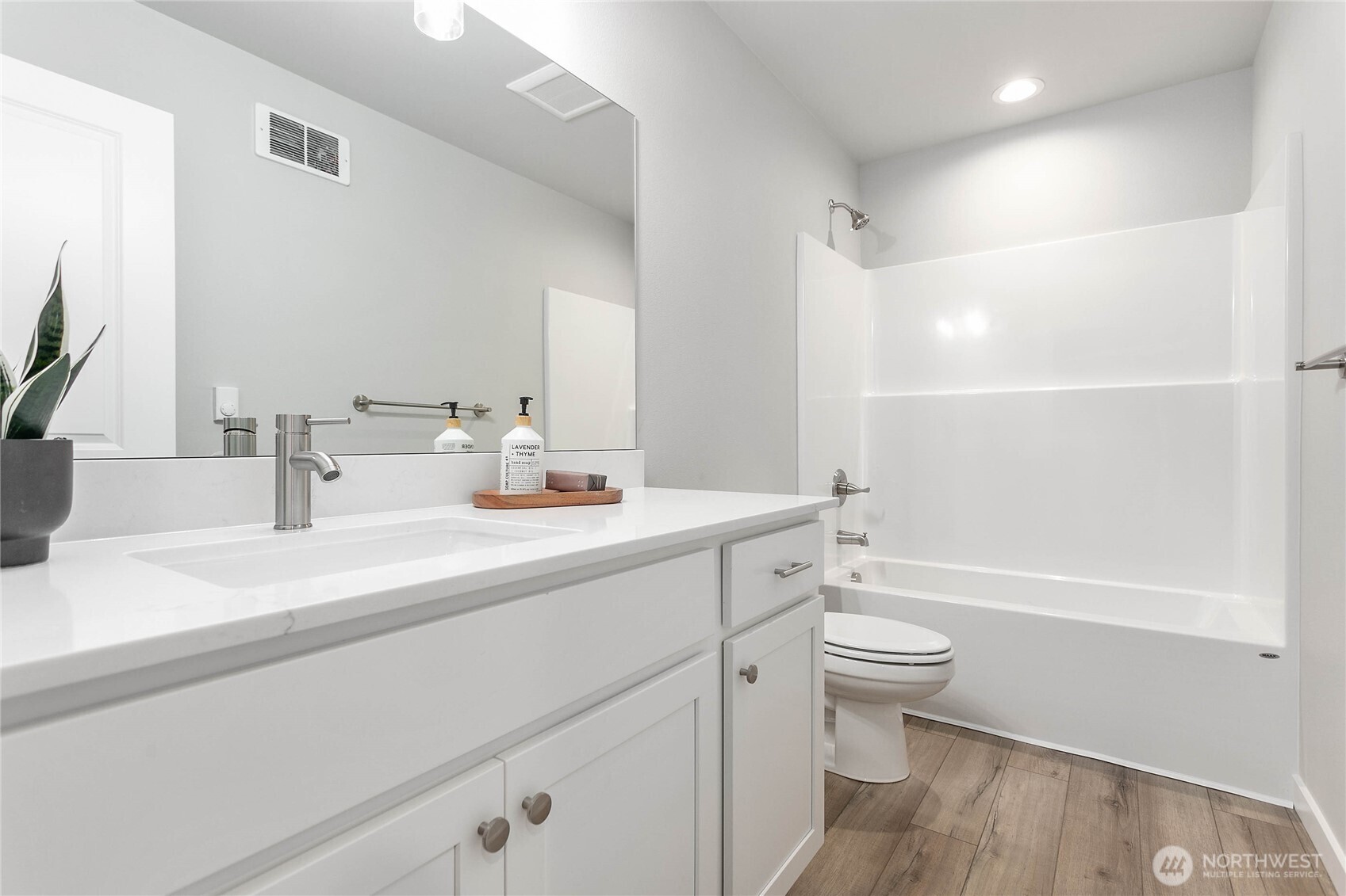 310 Everson Road, Unit C Everson, WA 98247 - Photo 24 of 37 a bathroom with a sink a toilet and a large mirror