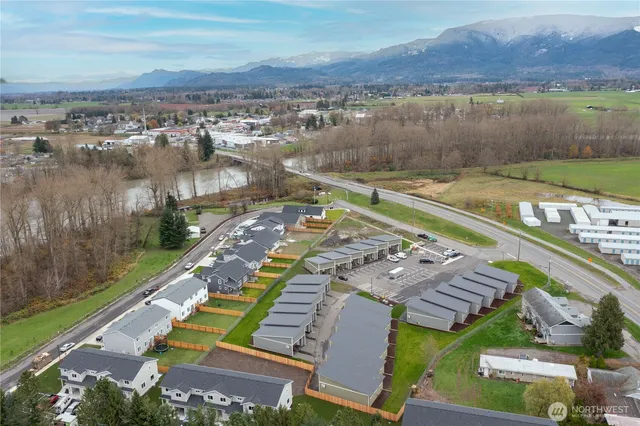 an aerial view of residential houses with outdoor space and river